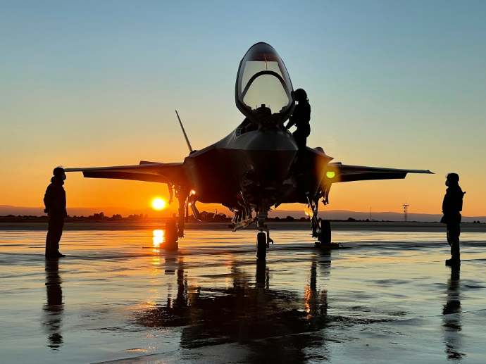 a fighter jet sitting on top of an airport tarmac